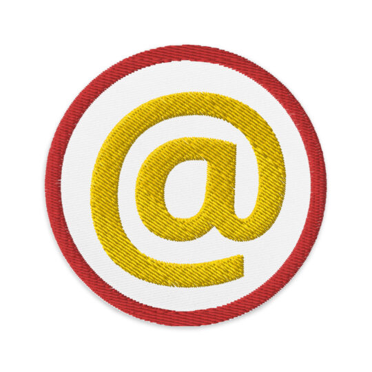 3 inch red circle patch with a red outline around a white patch. With a gold "@" symbol in the middle.