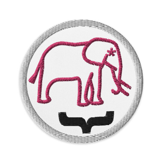 3 inch circle patch with a light grey outline around a white background. With the outline of a pink hot pink elephant with asterisk as its eyes and a black curly bracket underneath it. denim and patches