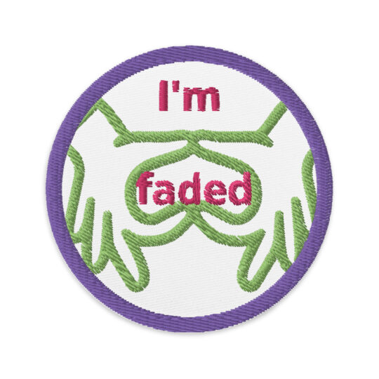 3 inch circle patch with a purple outline around a white background. With the phrase "I'm faded" written in a hot pink text with "I'm" centered at the top. And "faded" in the center of the outline of 2 hands making a heart upside down so it acts as "goggles". denimandpatches