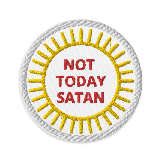 3 inch circle patch with a white outline that kind of blends in with the whit background. With the outline of a sun centered in the circle with the words "NOT TODAY SATAN" in the center. The words are written in red. denimandpatches