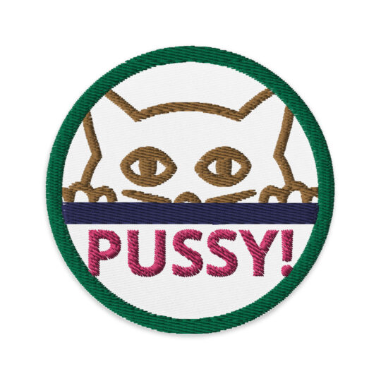 3 inch circle patch with a green outline around a white outline. Inside the circle is a the gold outline of the face of a cat with their paws on the edge of a counter or table that's dark blue. Underneath the image it says "PUSSY!" in hot pink. denimandpatches