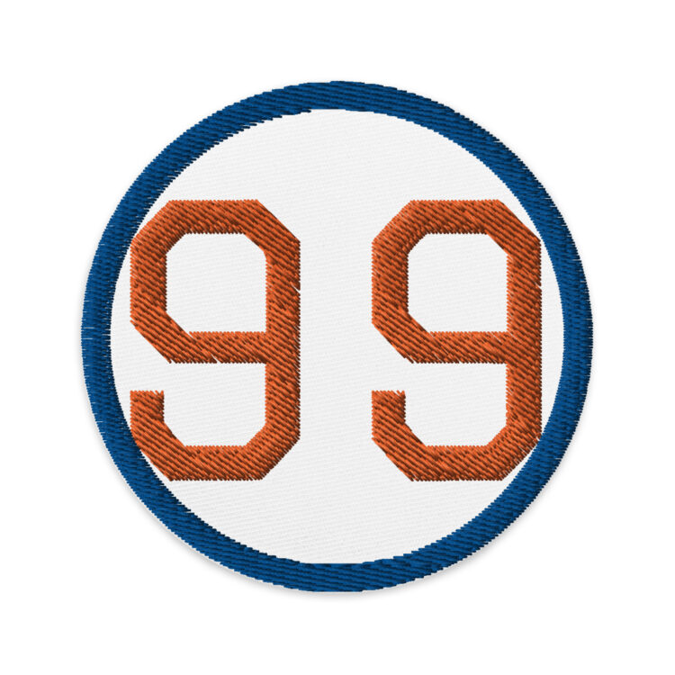 3 inch circle patch with a navy blue outline around a white background. With a orange "99" written in NFL edge font centered in the circle. denimandpatches