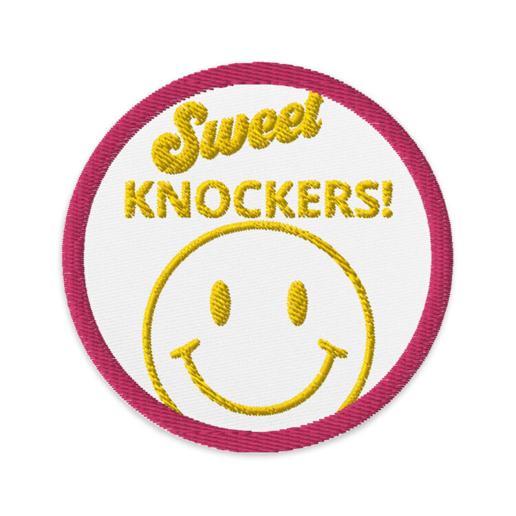 3 inch circle patch with a pink outline and a white background. With the words "Sweet Knockers!" written in a yellow lettering centered above a yellow smiley face. denimandpatches