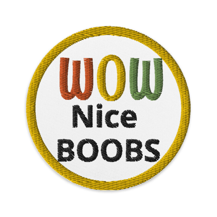 3 inch circle patch with a yellow outline around a white background. And the words "WOW Nice BOOBS" written in varying colors. "WOW" Having a red "W", yellow "O", and green "W". And "Nice BOOBS" written in black lettering. denimandpatches