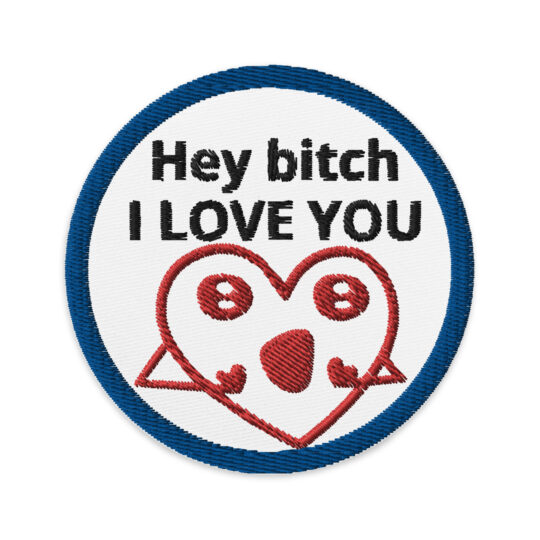3 inch circle patch featuring blue bold outline with a white background. And the words "Hey bitch I LOVE YOU" written in black. Centered above a heart with a face and 2 hands doing a yelling motion. denimandpatches