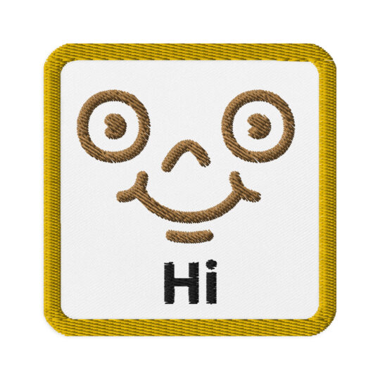 3 inch square shaped patch with a gold outline around a white background. With a brown detailed smiley face centered in the square. Right underneath the face is the word "Hi". denim and patches