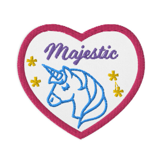 3 inch heart shaped patch with a pink outline around a white background. Featuring the word "Majestic" written in cursive centered at the top of the heart. Underneath the word it has the outline of a unicorn in blue with 4 stars around the unicorn. denimandpatches