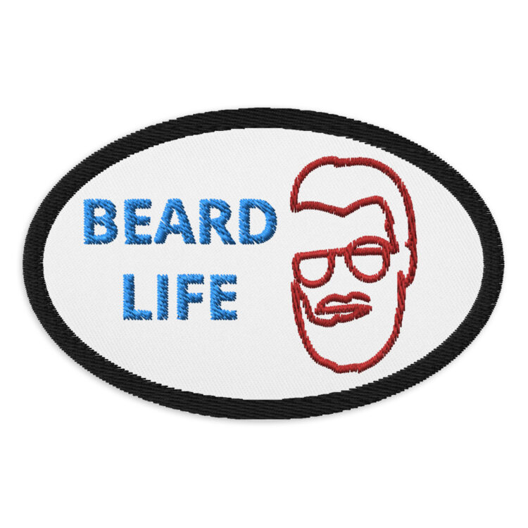 3 inch oval shaped patch with a black outline around a white background. Featuring "BEARD LIFE" written in blue with outline of the face of a bearded man in red to the right of the words. denimandpatches
